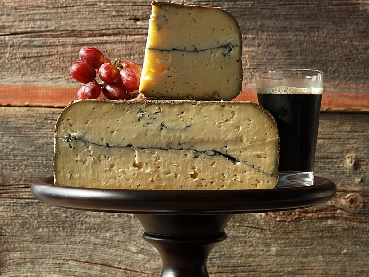 A washed rind Gouda cheese with the traditionasl ash line in the midd ...